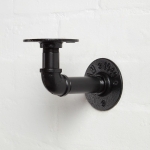 powder coated black curved elbow pipe shelf bracket close up