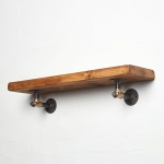 raw steel industrial pipe shelf bracket detailing reclaimed wood shelf