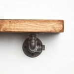 Raw steel industrial pipe with detailing shelf brackets close up