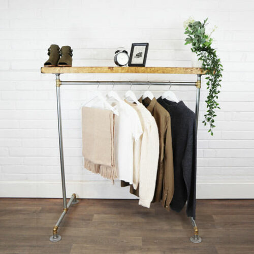 industrial steel industrial pipe clothes rail with brass elbows and reclaimed wood shelf