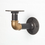 raw steel brass curved elbow shelf bracket close up