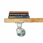 Industrial pipe with oak shelf bracket close up